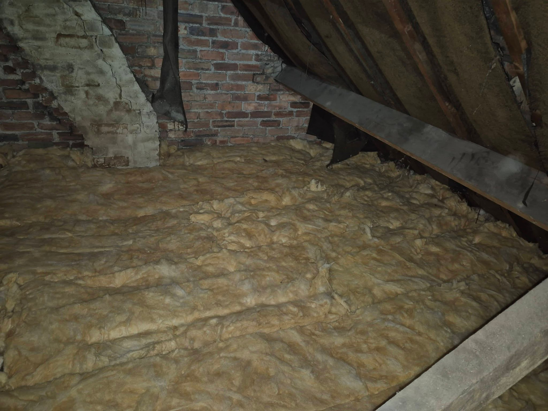 Loft space fitted with thick insulation between roof timbers